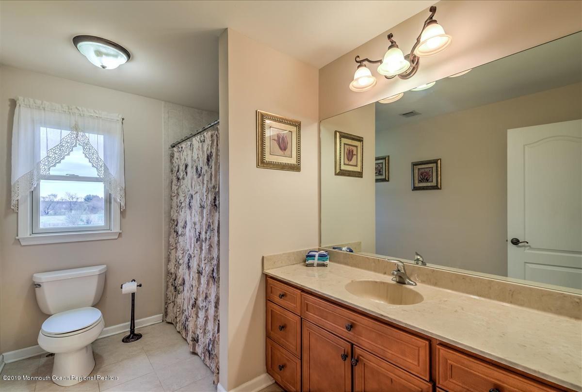 3 Yellow Meetinghouse Road Millstone Township, NJ 08510 - Photo 23 of 29 a bathroom with a toilet sink and mirror