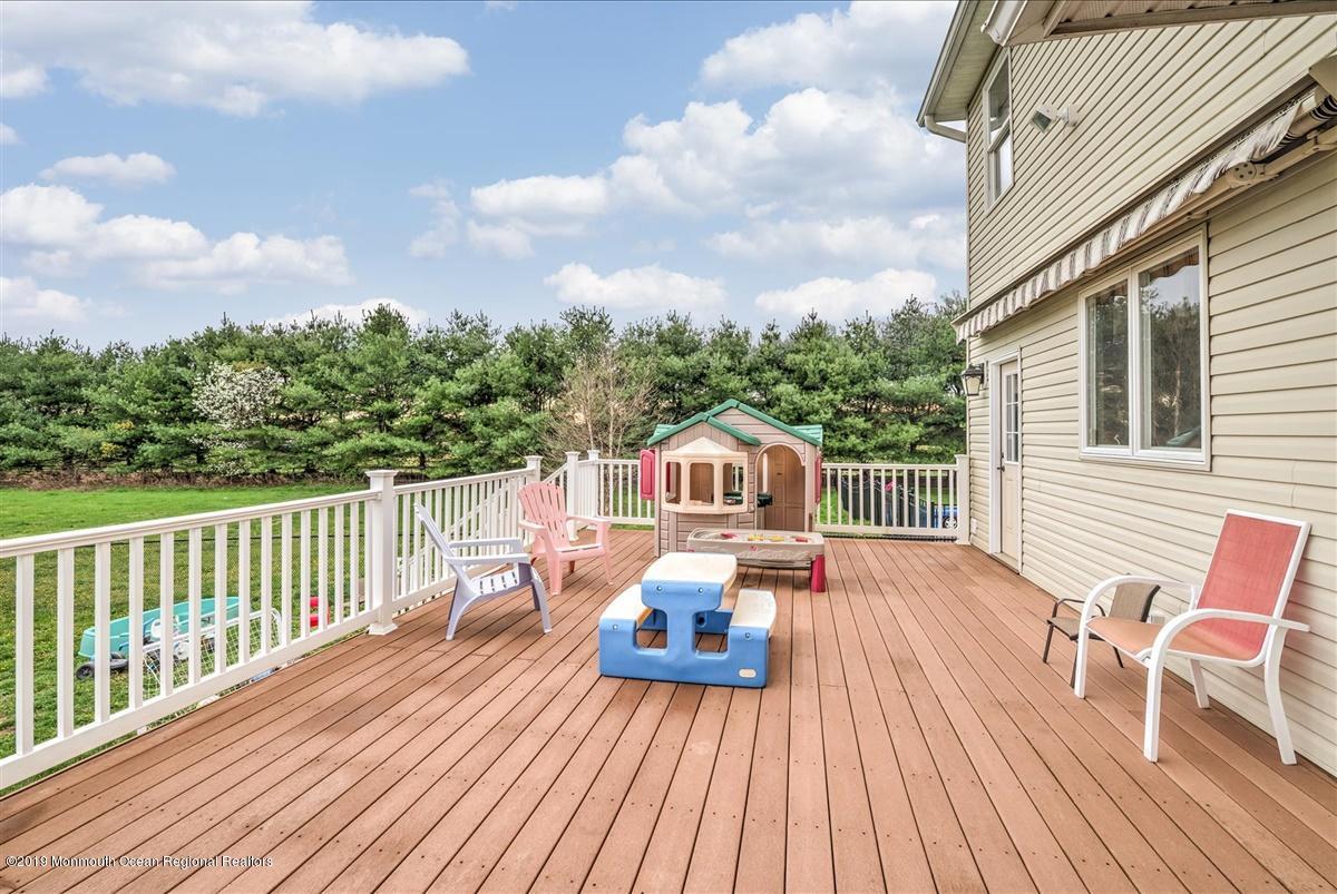 3 Yellow Meetinghouse Road Millstone Township, NJ 08510 - Photo 26 of 29 a view of a roof deck with table and chairs a barbeque with wooden floor and fence
