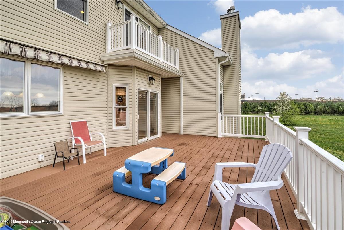 3 Yellow Meetinghouse Road Millstone Township, NJ 08510 - Photo 27 of 29 a view of a roof deck with chair and wooden floor