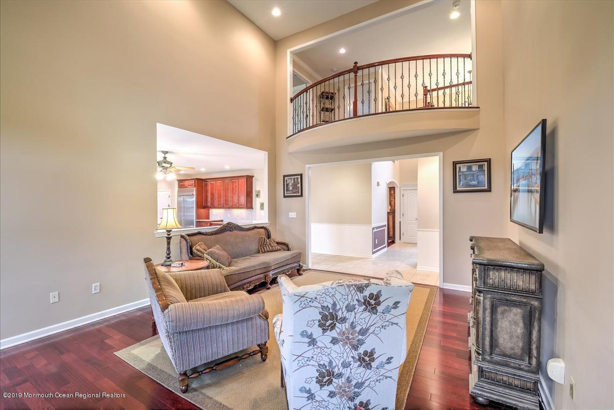 3 Yellow Meetinghouse Road Millstone Township, NJ 08510 - Photo 7 of 29 a living room with furniture a flat screen tv and kitchen view
