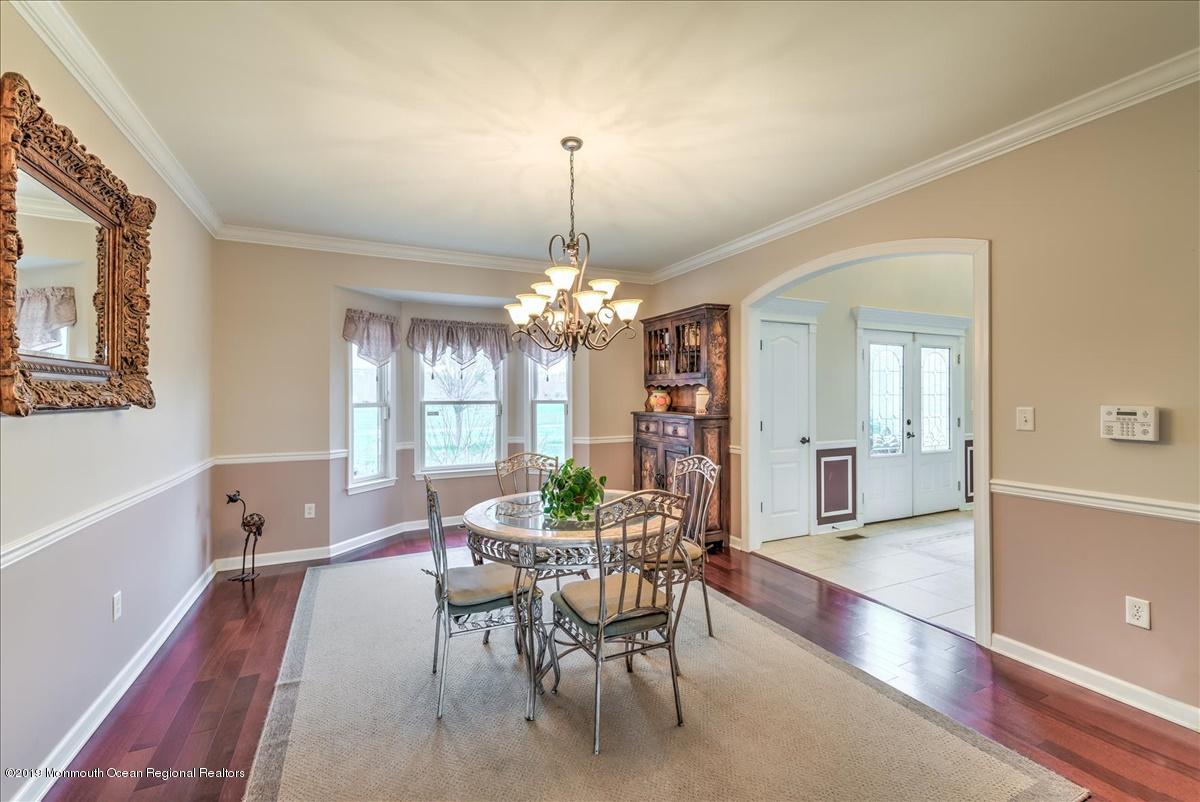 3 Yellow Meetinghouse Road Millstone Township, NJ 08510 - Photo 10 of 29 a dining room with furniture a chandelier and wooden floor