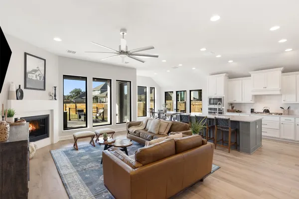 a living room with furniture fireplace and flat screen tv