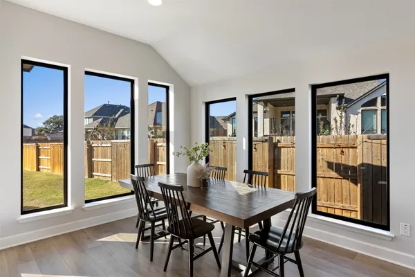 a view of a dining room with furniture window and wooden floor