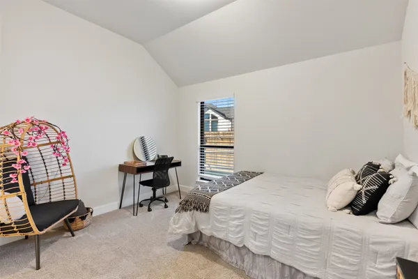 a bedroom with a bed and a chair