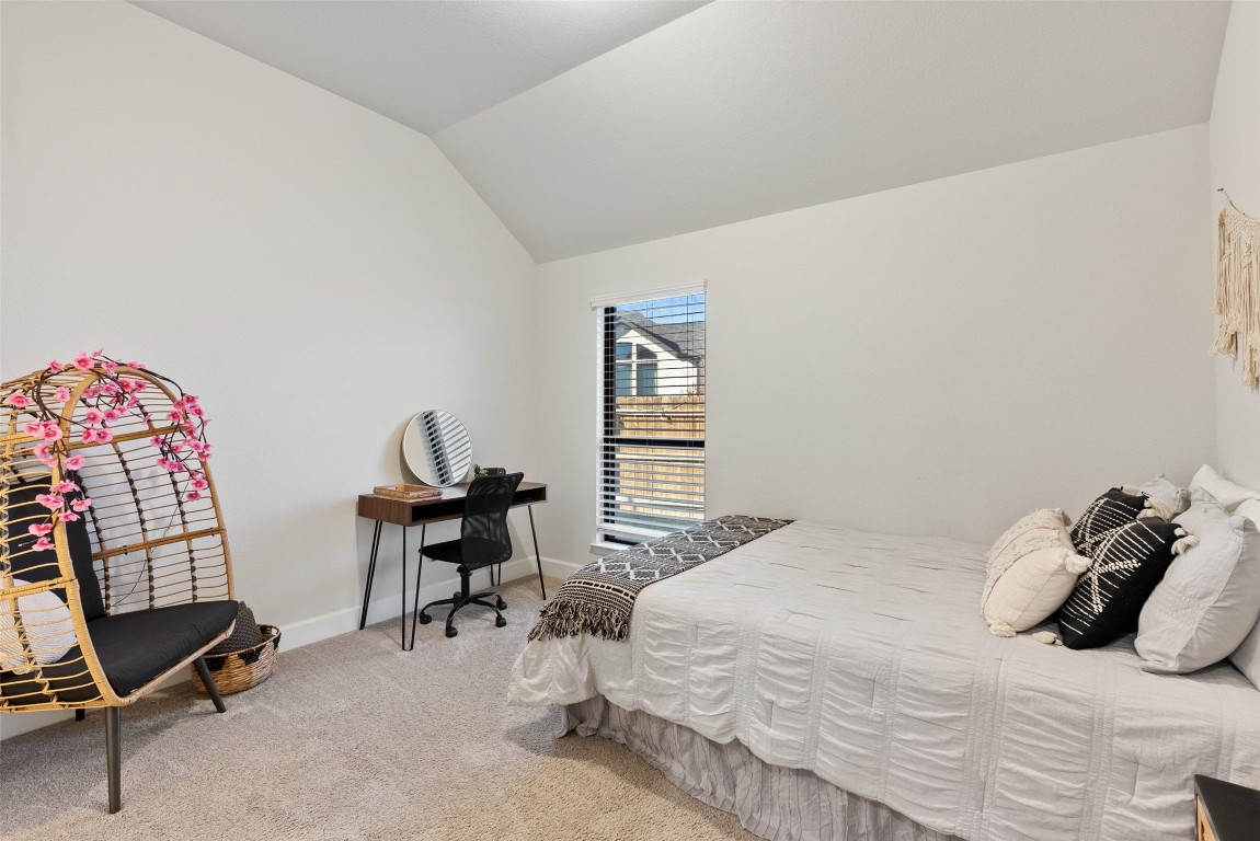 321 Allegheny Way Kyle, TX 78640 - Photo 20 of 40 Carpeted bedroom featuring lofted ceiling and baseboards