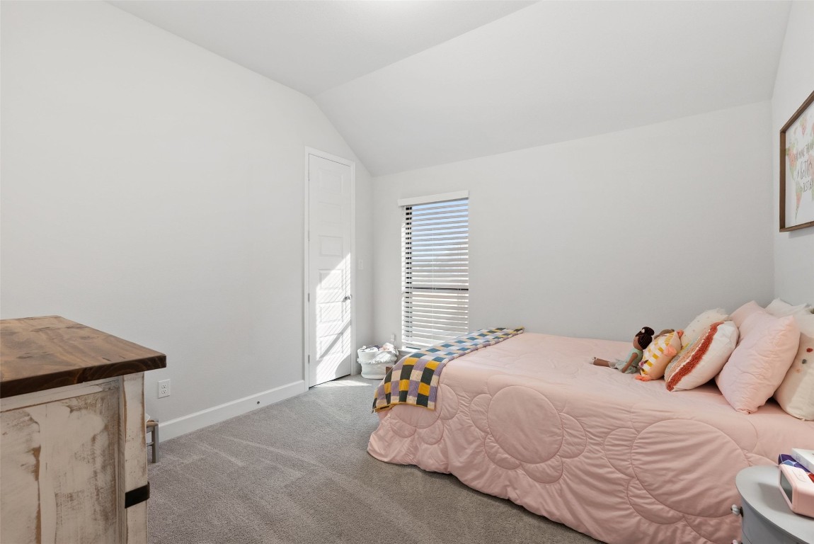 321 Allegheny Way Kyle, TX 78640 - Photo 23 of 40 Bedroom with carpet flooring and lofted ceiling