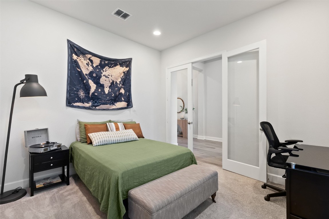 321 Allegheny Way Kyle, TX 78640 - Photo 27 of 40 Bedroom with a desk, french doors, recessed lighting, and light colored carpet