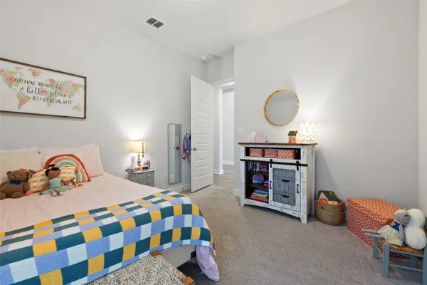 a bedroom with a bed and a dresser