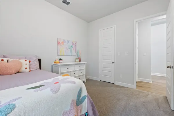 a bedroom with a bed and a cabinets