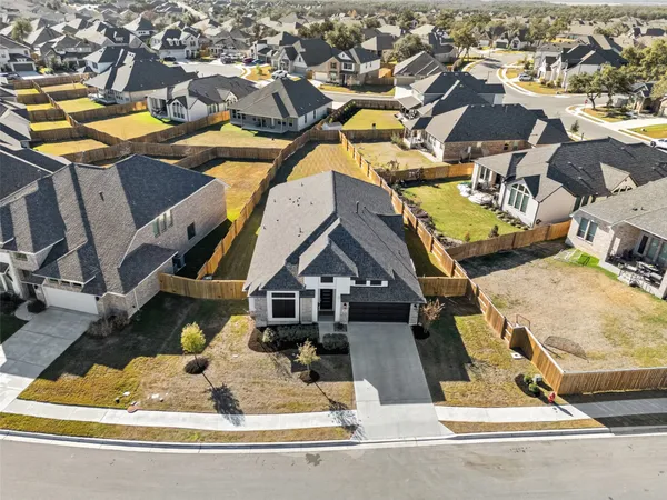 an aerial view of a house with a swimming pool
