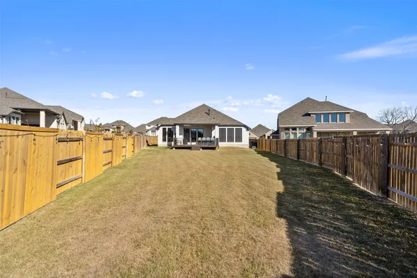 a view of a house with wooden fence
