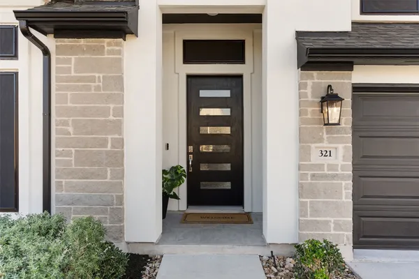 a view of front door and potted plants