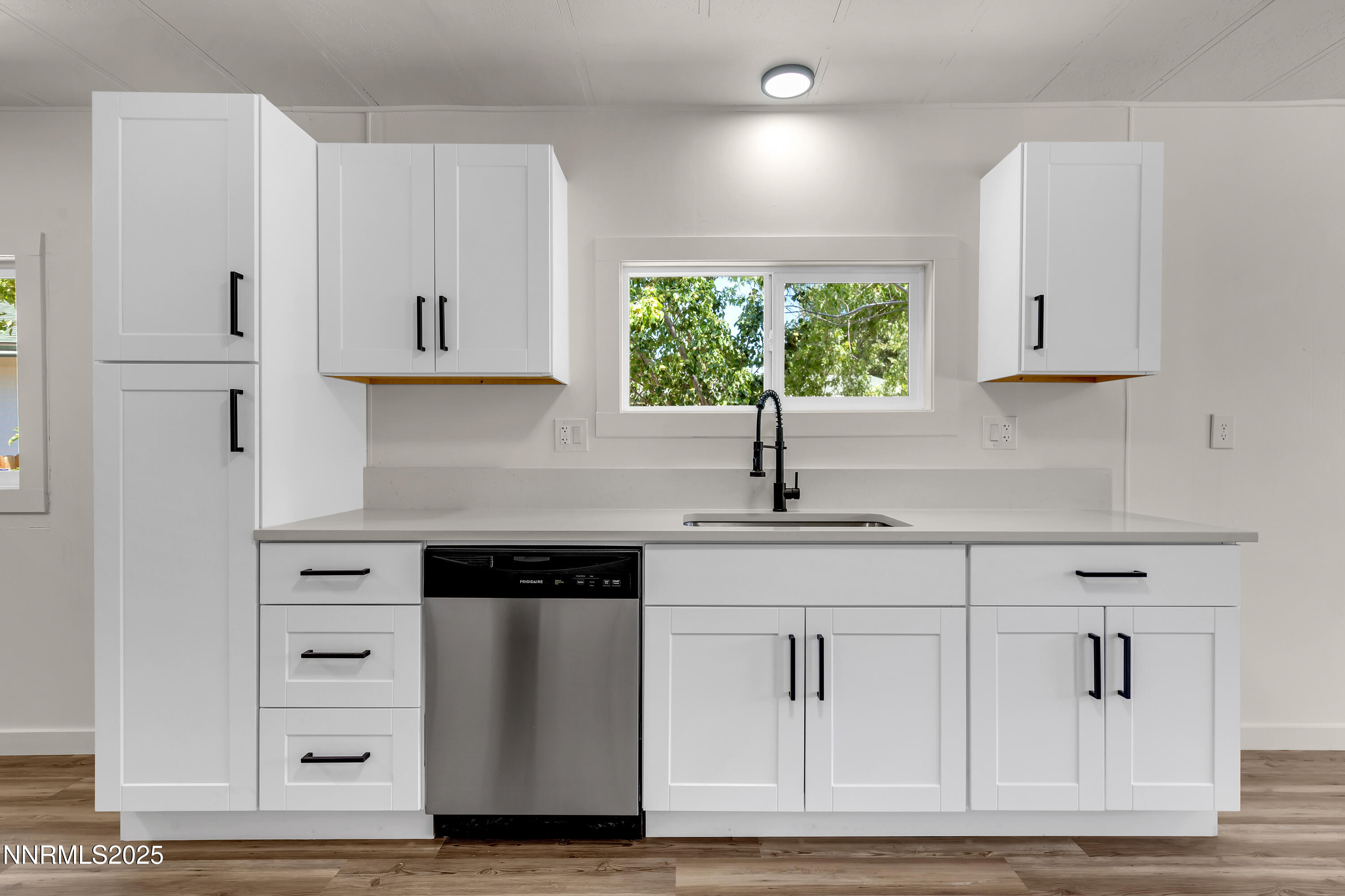 16385 Rhyolite Circle Reno, NV 89521 - Photo 15 of 50 a kitchen with white cabinets and window