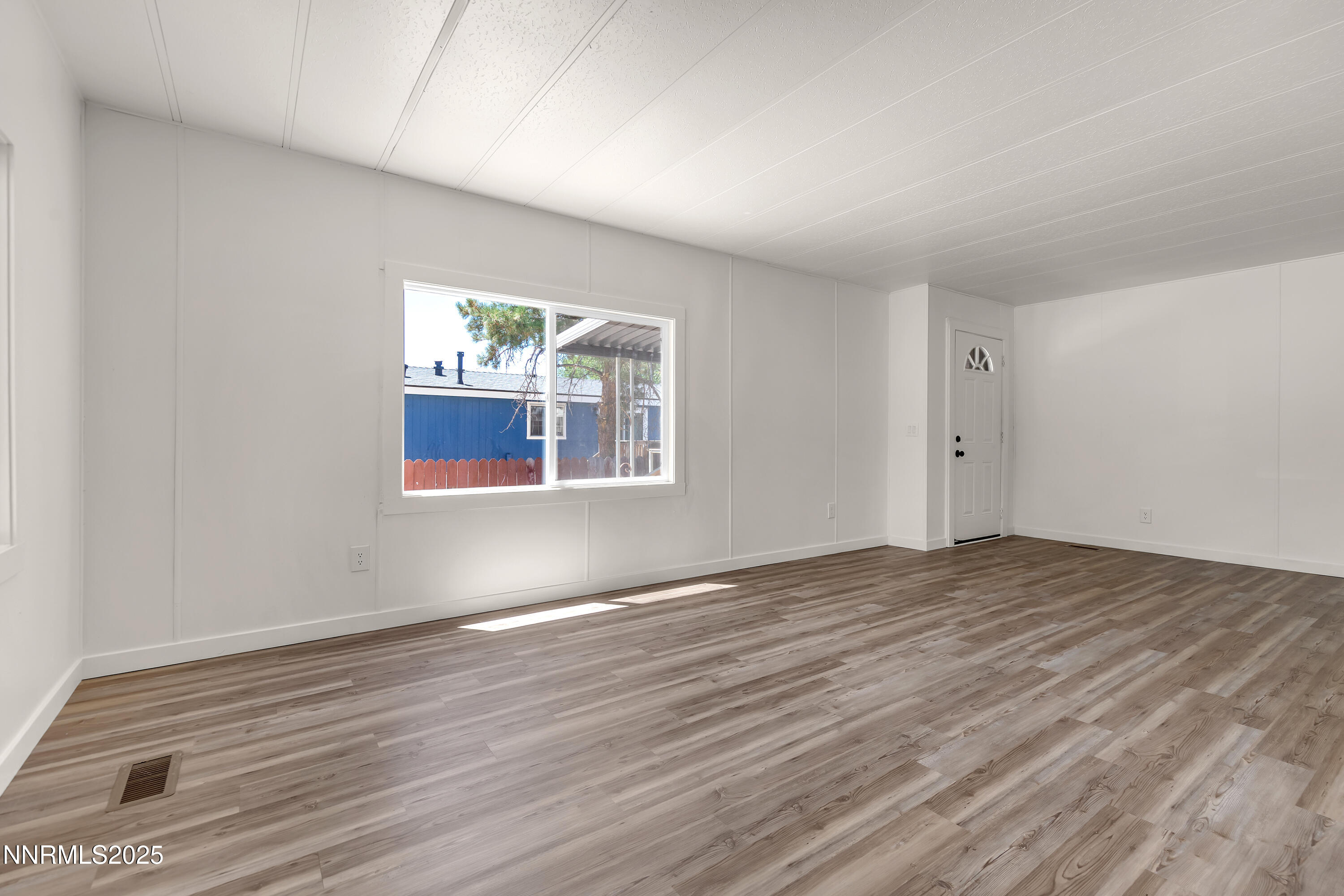 16385 Rhyolite Circle Reno, NV 89521 - Photo 5 of 50 a view of empty room with wooden floor and fan
