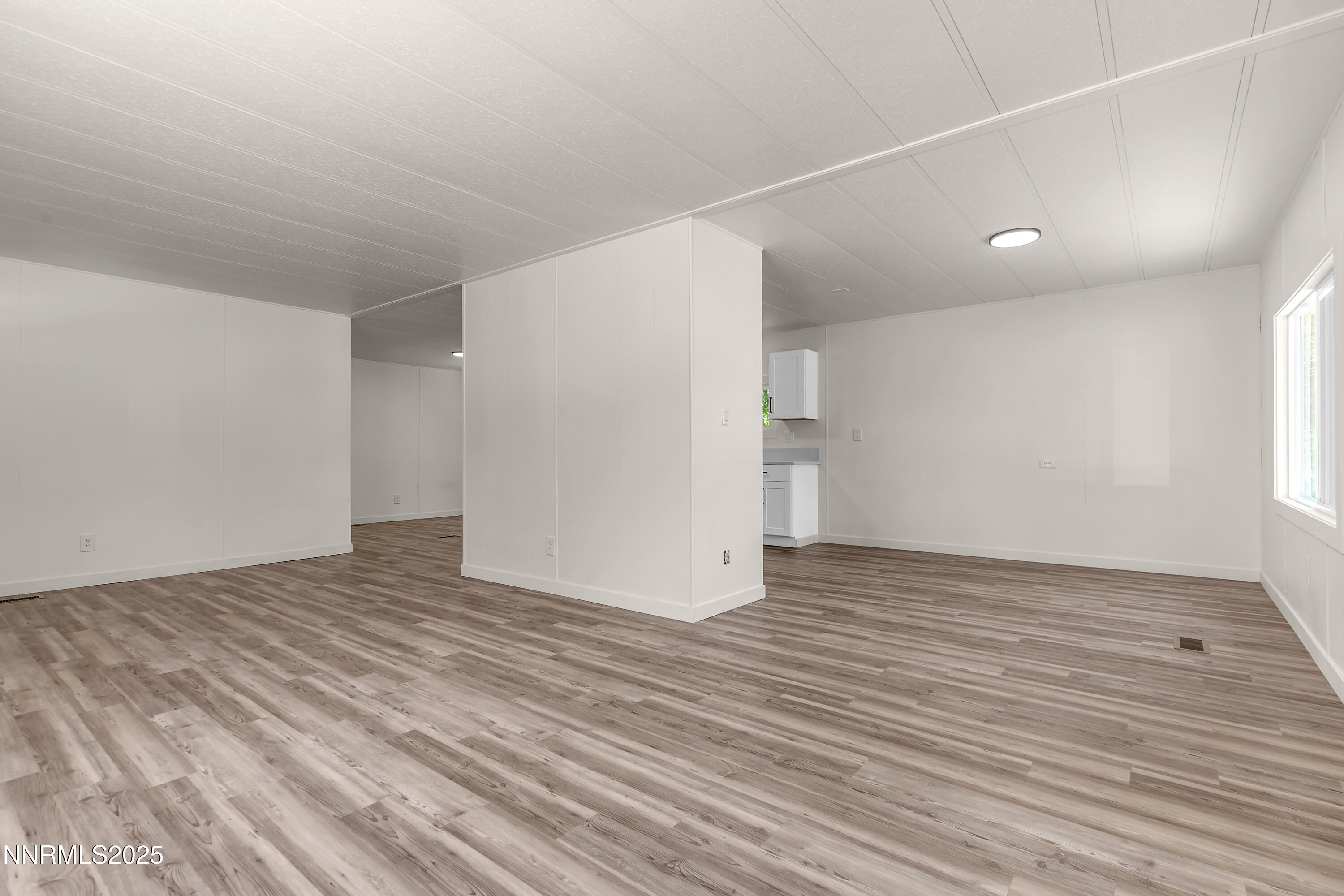 16385 Rhyolite Circle Reno, NV 89521 - Photo 6 of 50 a view of an empty room with wooden floor