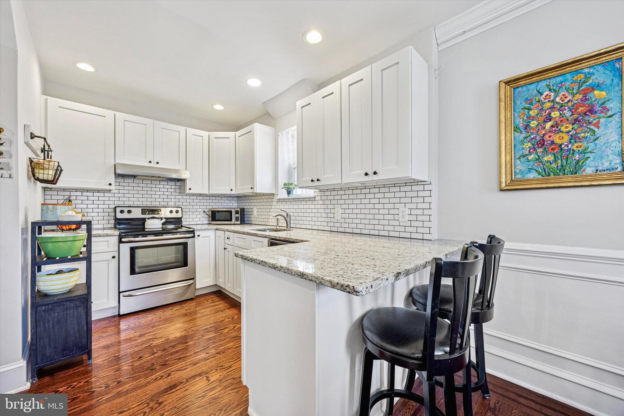 507 East Ridley Avenue Ridley Park, PA 19078 - Photo 7 of 18 a kitchen with granite countertop white cabinets and stainless steel appliances