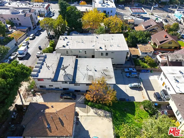 an aerial view of residential houses with outdoor space