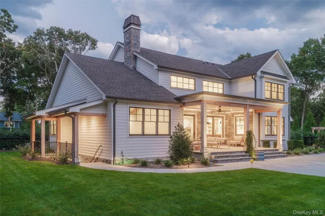 a front view of a house with a garden and yard