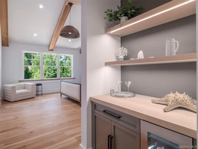 a front view of a house with porch and chairs