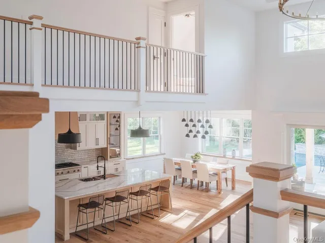 a kitchen with kitchen island granite countertop a table and chairs in it