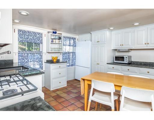 42 Elm Street Marblehead, MA 01945 - Photo 11 of 28 a kitchen with a table chairs and a refrigerator