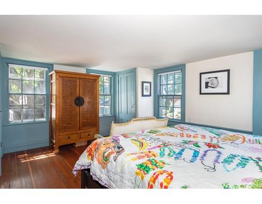 42 Elm Street Marblehead, MA 01945 - Photo 15 of 28 a bedroom with a bed and wooden floor