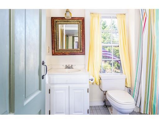 42 Elm Street Marblehead, MA 01945 - Photo 20 of 28 a bathroom with a granite countertop toilet sink and mirror