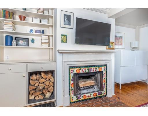 42 Elm Street Marblehead, MA 01945 - Photo 7 of 28 a living room with stainless steel appliances a fireplace and a flat screen tv