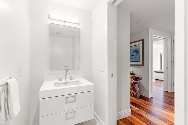 a bathroom with a sink a vanity and a mirror