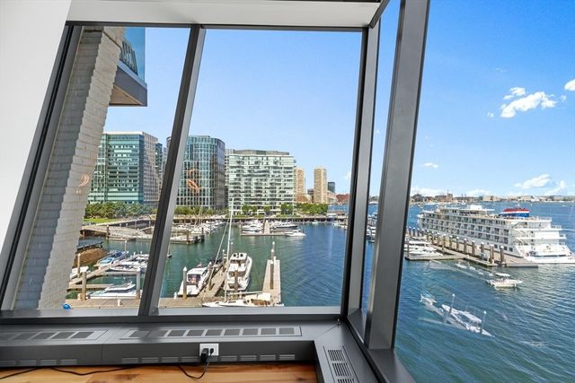 a view of a balcony with floor to ceiling windows with wooden floor