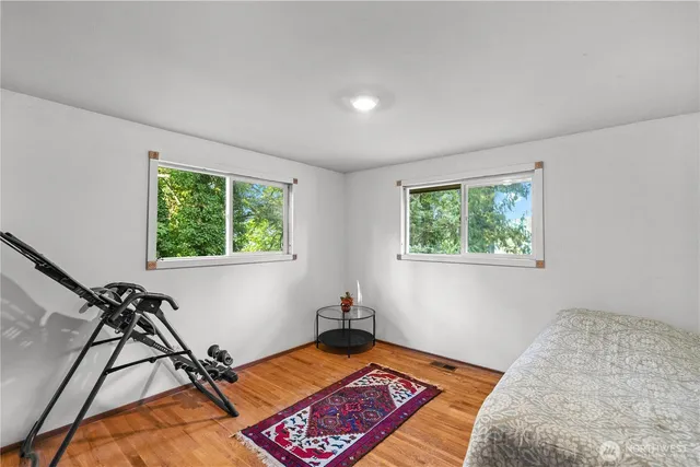 a bedroom with a bed and a mirror