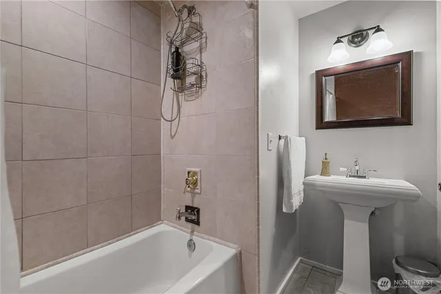 a bathroom with a sink a toilet and mirror