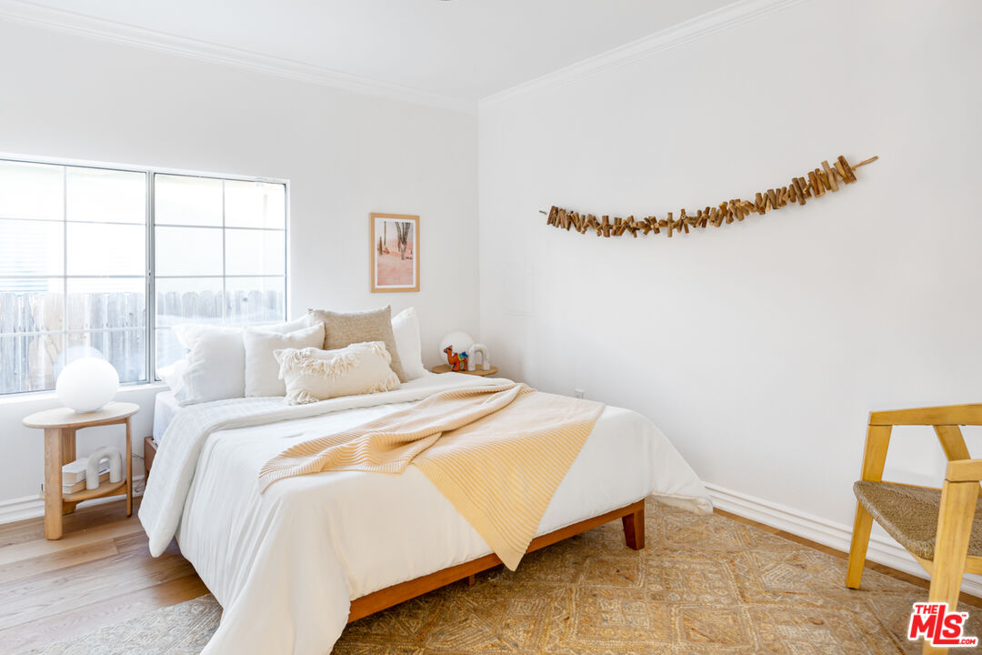 3420 Buckingham Road Los Angeles, CA 90016 - Photo 15 of 41 a bed room with a bed and a chair