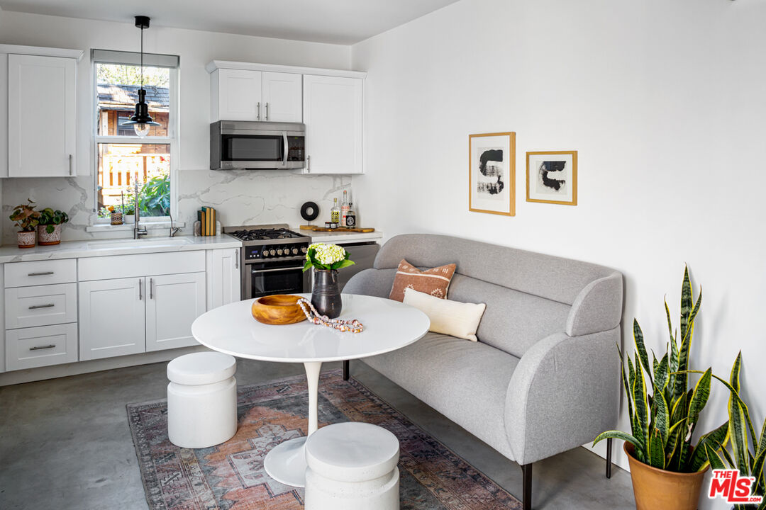 3420 Buckingham Road Los Angeles, CA 90016 - Photo 32 of 41 a living room with furniture a kitchen and a sink
