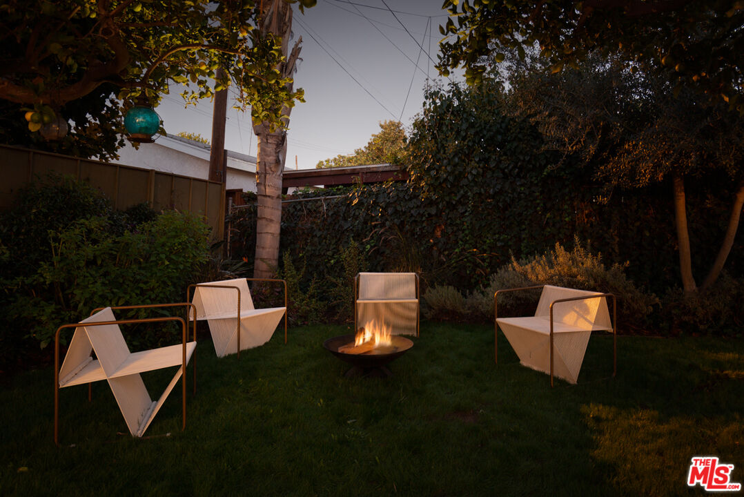3420 Buckingham Road Los Angeles, CA 90016 - Photo 37 of 41 a backyard of a house with table and chairs