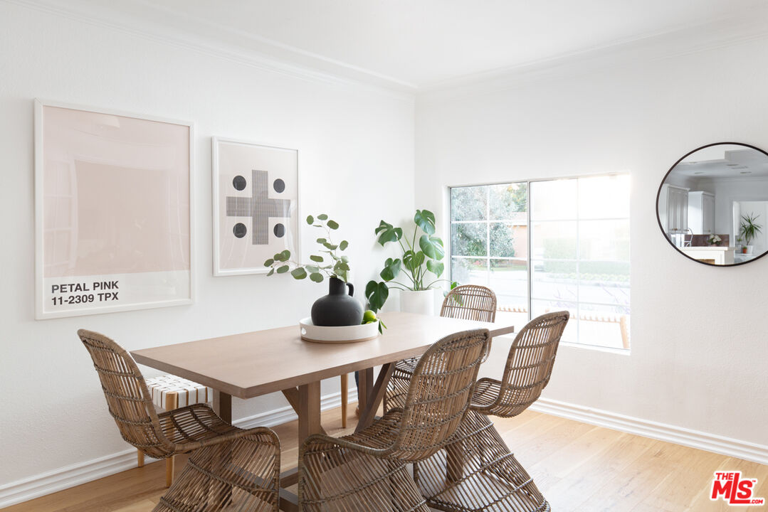 3420 Buckingham Road Los Angeles, CA 90016 - Photo 7 of 41 a dining room with furniture a rug and a potted plant