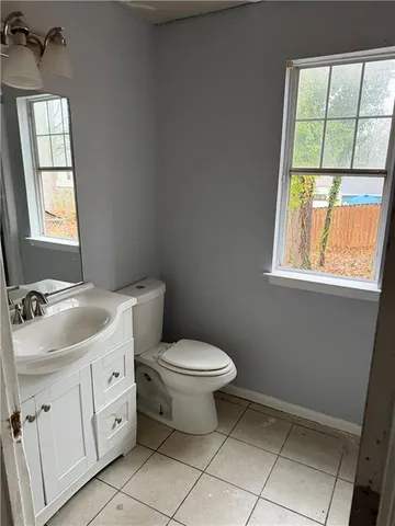 a bathroom with a toilet sink and window