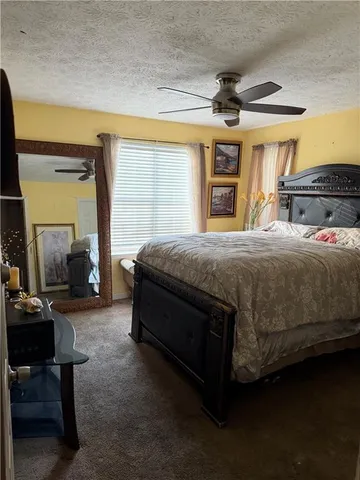 a bedroom with a bed wooden floor and a window