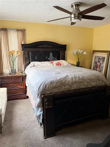 a bedroom with a bed and window