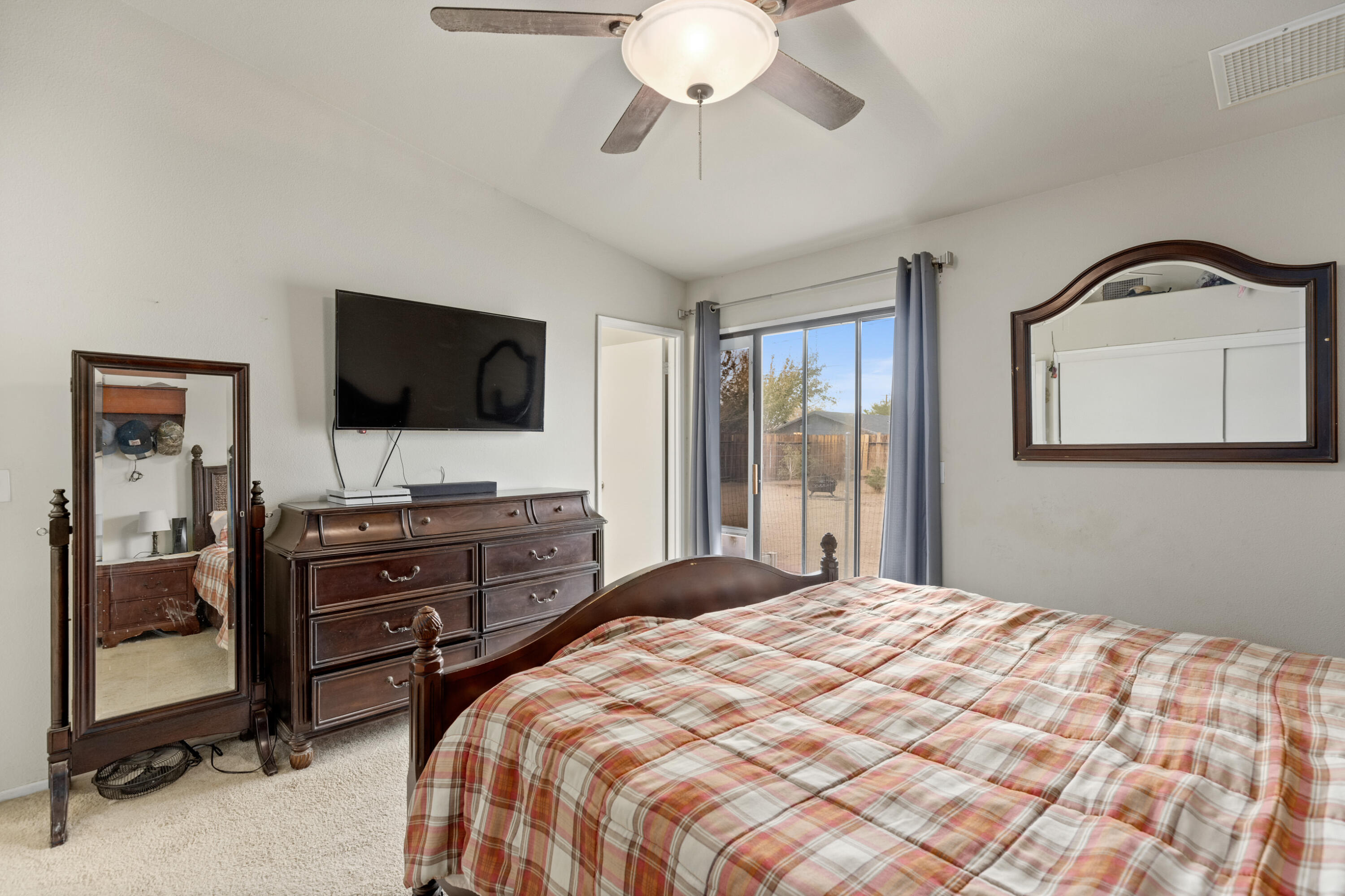 920 West Perch Avenue Ridgecrest, CA 93555 - Photo 17 of 26 a bedroom with a bed and a flat tv screen on dresser