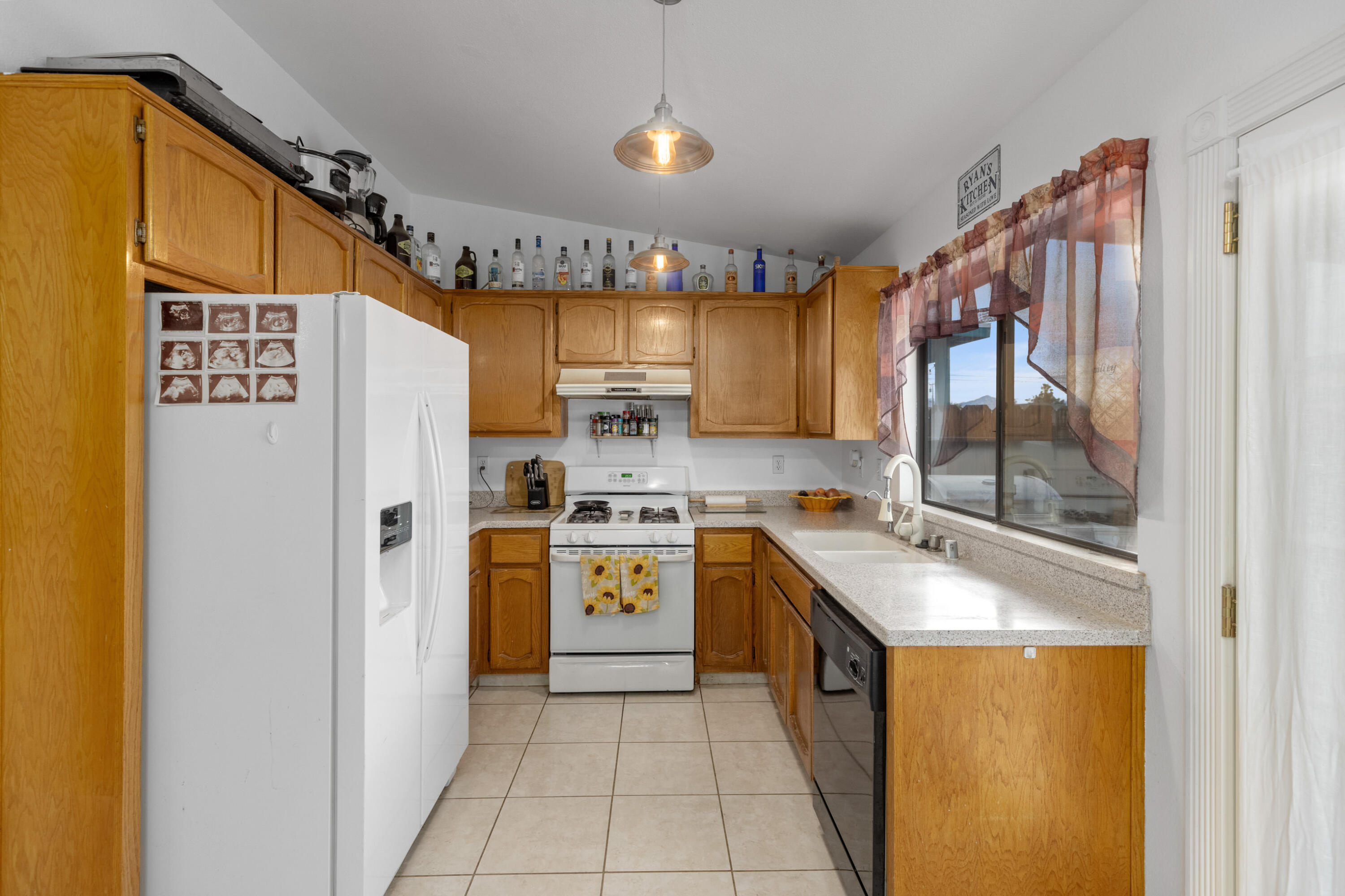 920 West Perch Avenue Ridgecrest, CA 93555 - Photo 10 of 26 a kitchen with stainless steel appliances granite countertop a refrigerator and a stove top oven