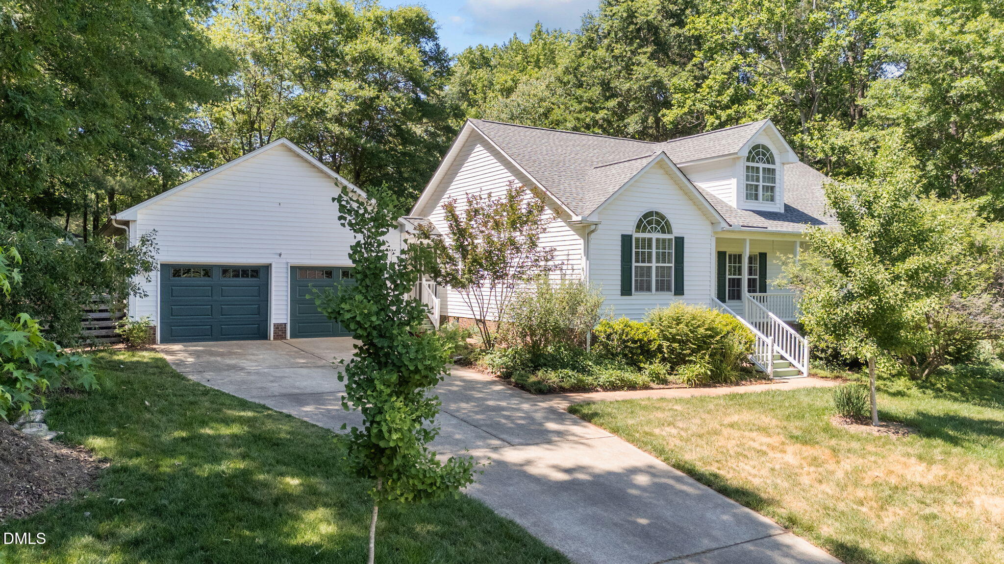 6820 Oviedo Drive Raleigh, NC 27603 - Photo 46 of 50 a front view of a house with a yard and trees