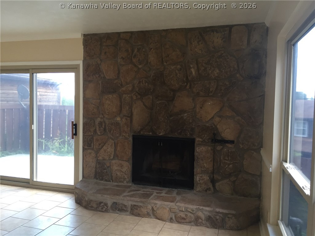 403 Powderhorn Road Charleston, WV 25314 - Photo 6 of 21 stone fireplace in living room. you can see the patio doors/patio to left.
