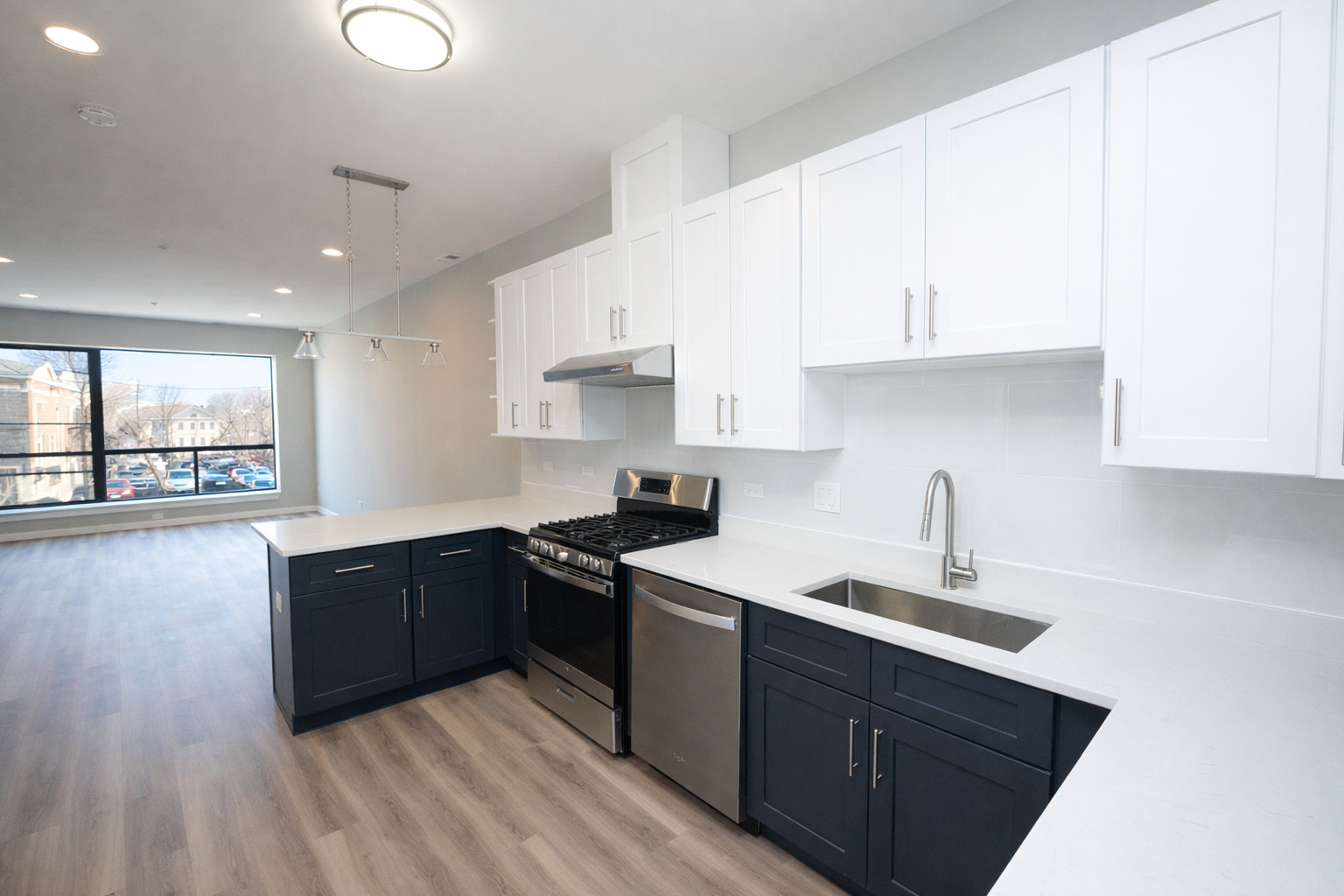3122 South Morgan Street Chicago, IL 60608 - Photo 17 of 33 a kitchen with stainless steel appliances granite countertop a sink stove and white cabinets with wooden floor