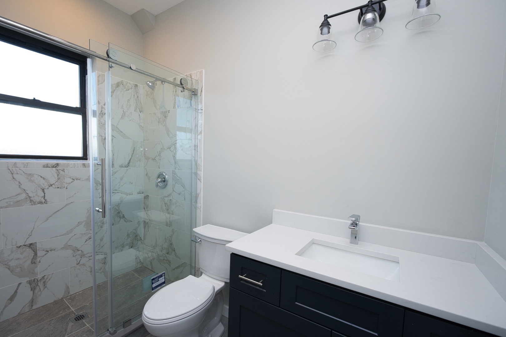 3122 South Morgan Street Chicago, IL 60608 - Photo 24 of 33 a bathroom with a sink a toilet and shower