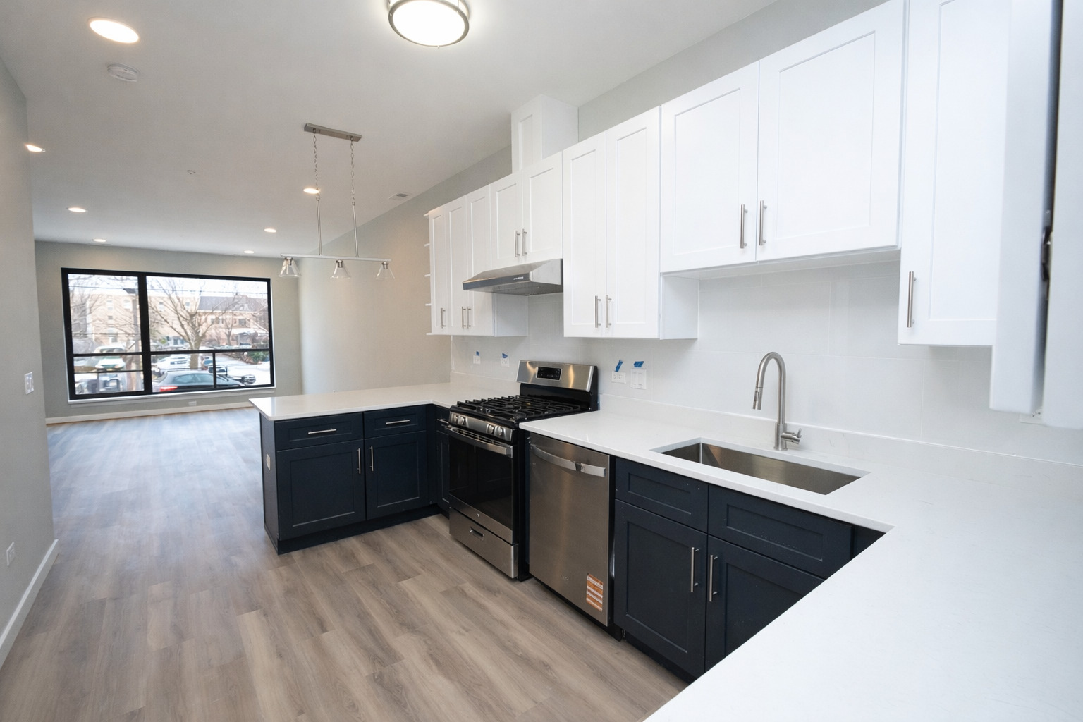 3122 South Morgan Street Chicago, IL 60608 - Photo 5 of 33 a kitchen with stainless steel appliances granite countertop a sink stove and white cabinets with wooden floor