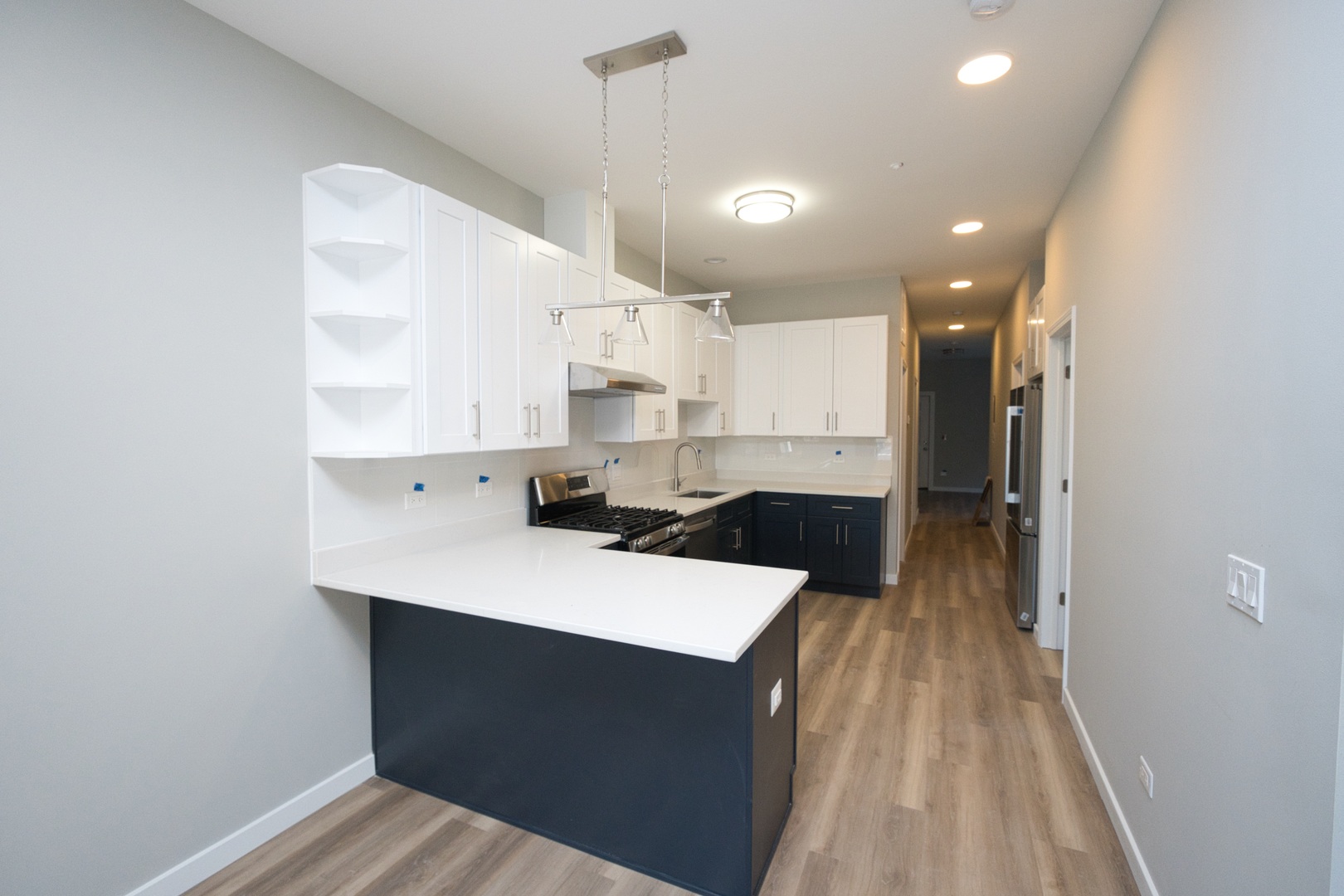 3122 South Morgan Street Chicago, IL 60608 - Photo 6 of 33 a kitchen with a sink a stove cabinets and wooden floor