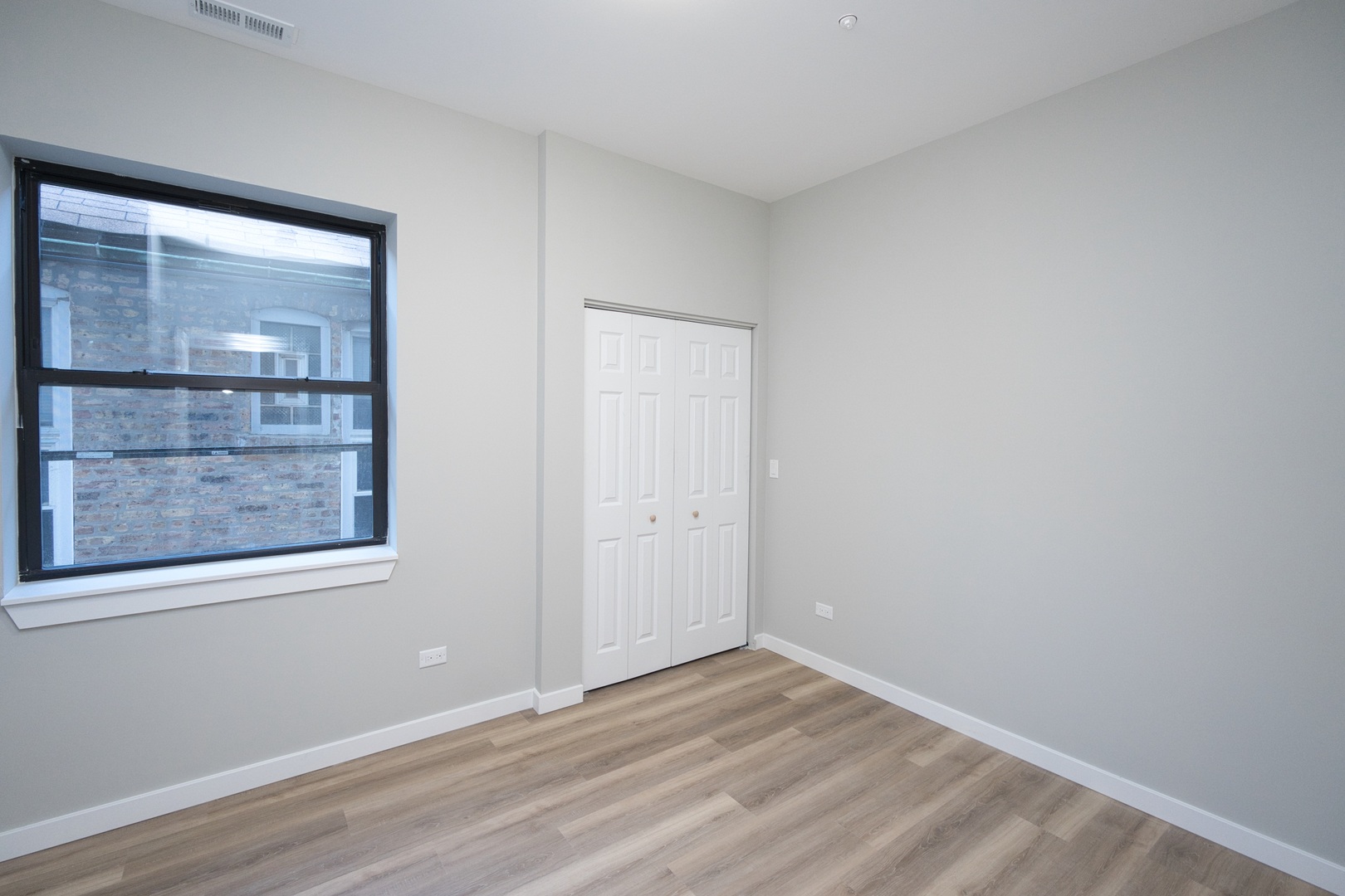 3122 South Morgan Street Chicago, IL 60608 - Photo 7 of 33 a view of a small space with wooden floor and a window