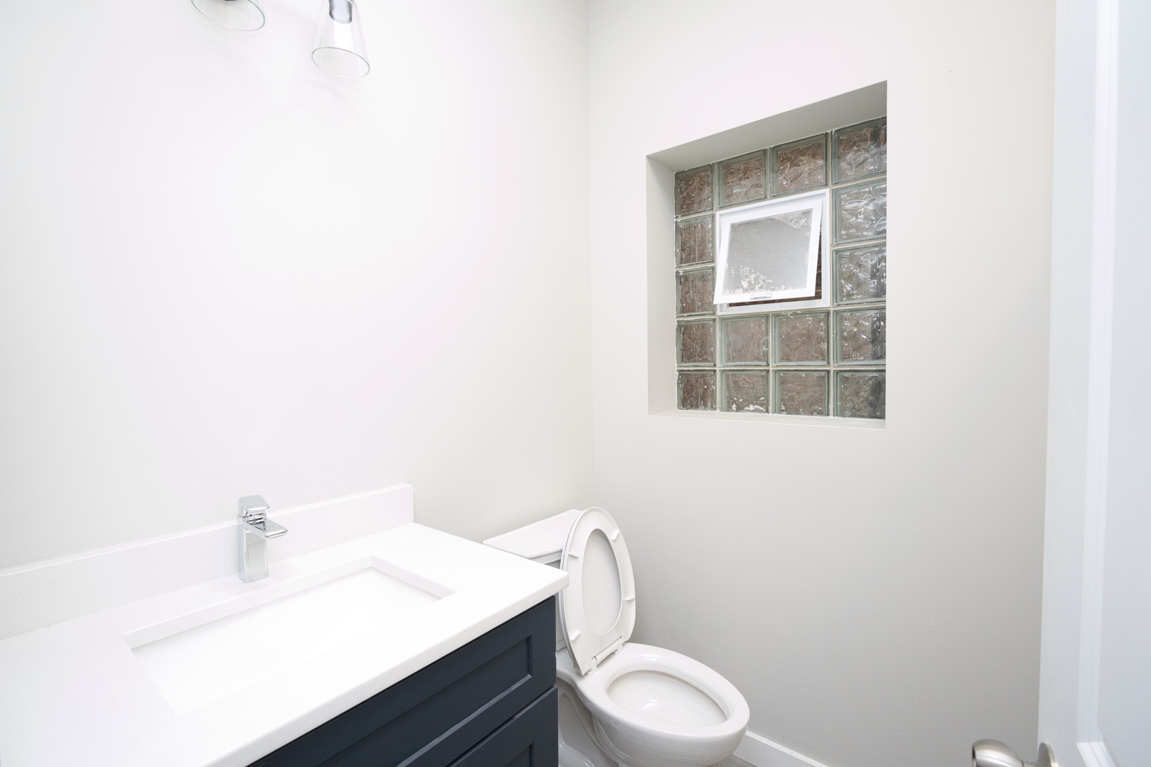 3122 South Morgan Street Chicago, IL 60608 - Photo 9 of 33 a bathroom with a sink a toilet and mirror