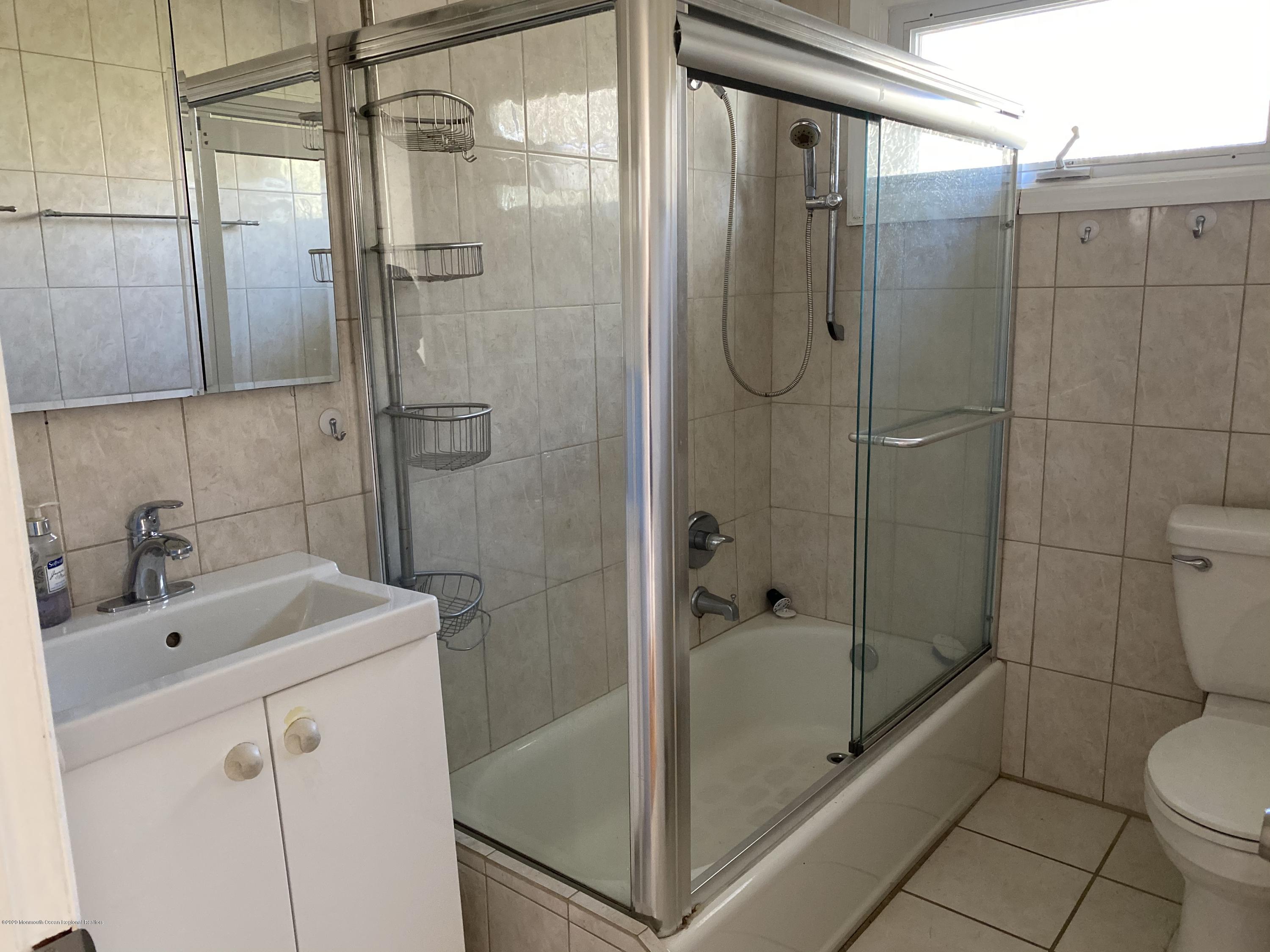 560 Central Avenue, Unit ANNUAL Spring Lake Heights, NJ 07762 - Photo 12 of 14 a bathroom with a bathtub shower sink mirror and toilet